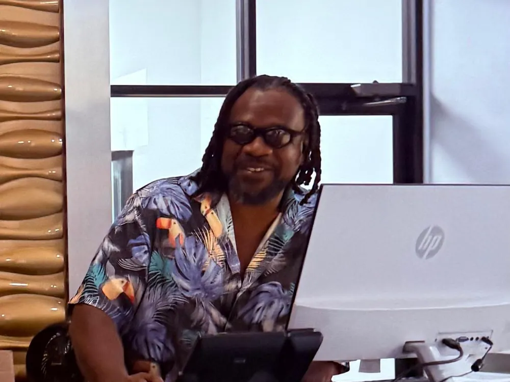 An Integrity 1st team member at their desk on a fun shirt Friday