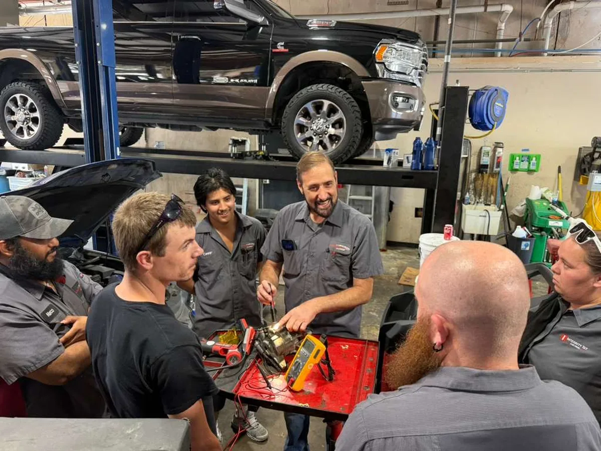 Integrity 1st technicians gathered around a toolbox during AC systems training