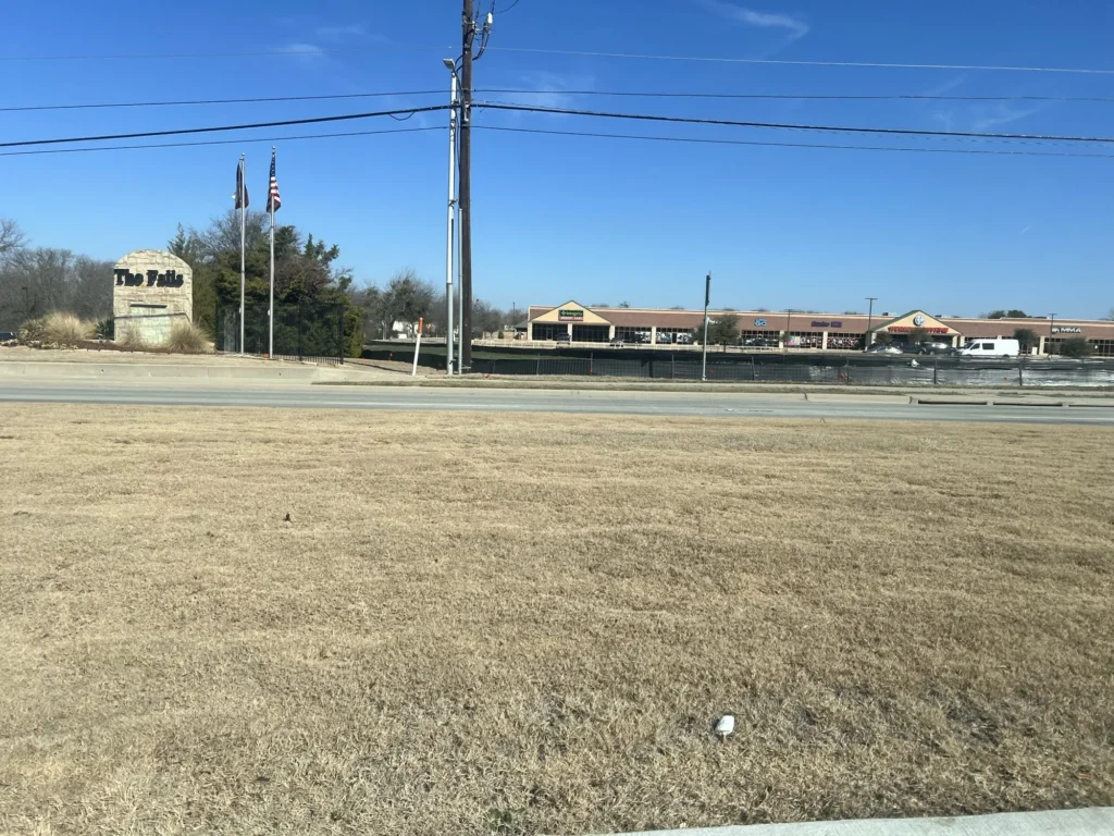 The empty lot in Anna, Texas in February 2026, before construction of the Integrity 1st Car Pros shop began