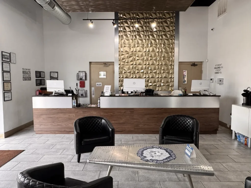 The reception desk and customer lounge at the Integrity 1st Car Pros shop on W 15th St in Plano