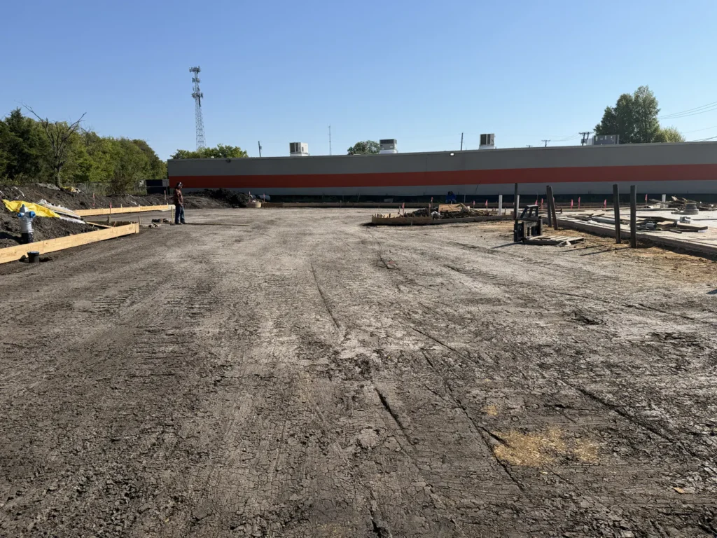 The graded building pad at the new Wylie site in October 2026, with timber forms set along its edge