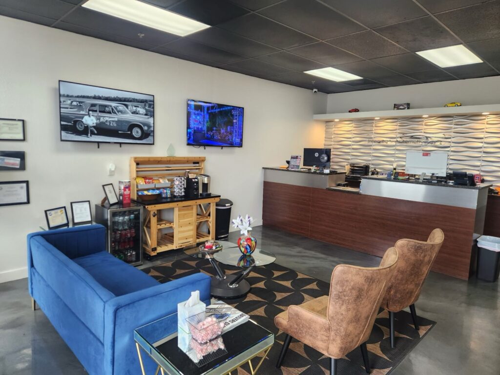 The customer lounge at the Wylie shop, with sofas, armchairs and a TV